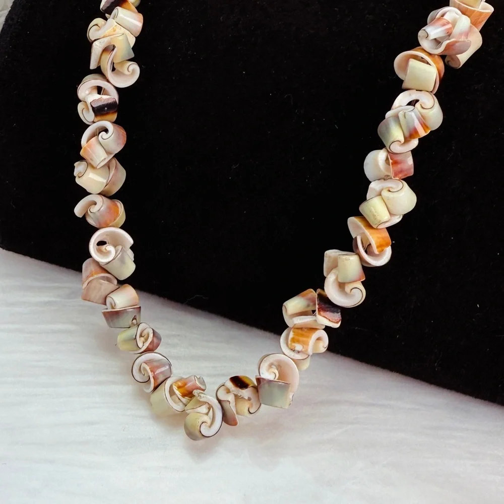 Beautiful vintage necklace composed of curly-cut conch shell beads individually